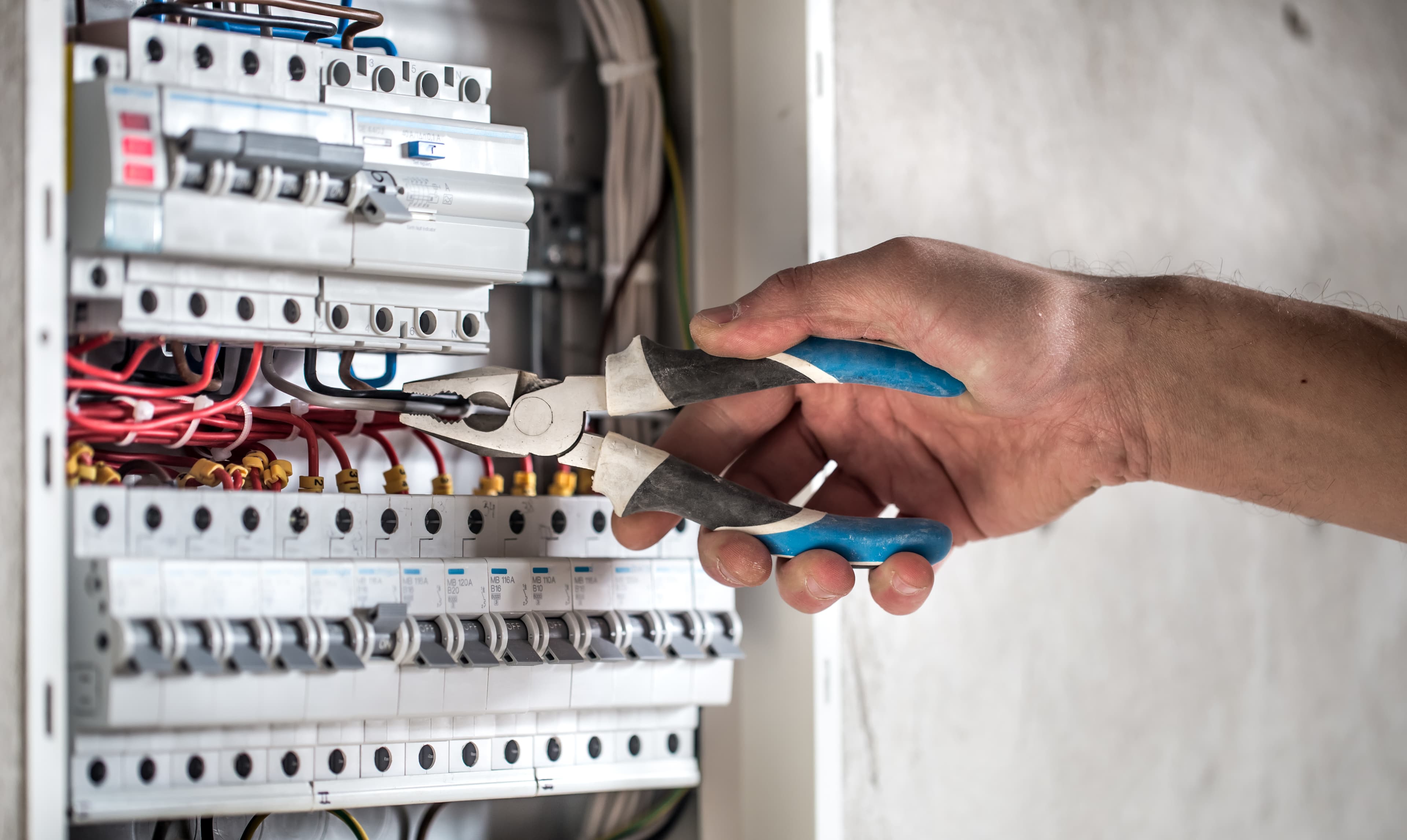 Electrician working on electrical panel